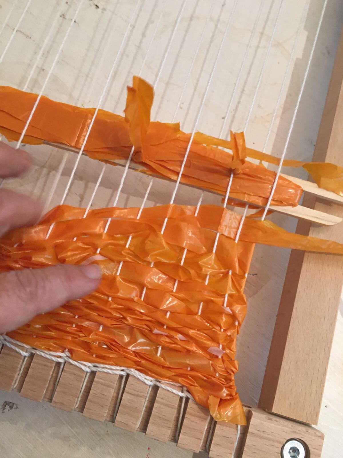 6push the woven pieces down to cover the warp